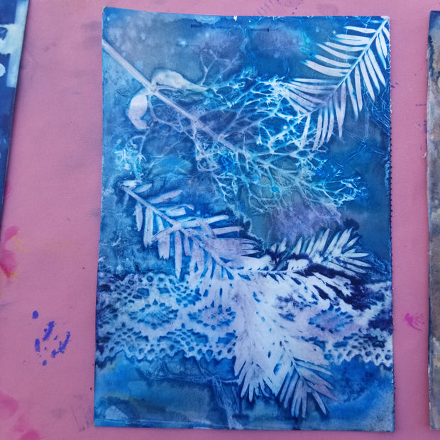 Artistic blue and white floral design on a pink background