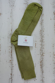 Green sock with a white label on a wooden surface