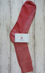 Red sock with a 'Chiara' label on a wooden surface