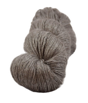 Earth coloured grey brown knitting yarn on a white background