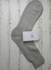 Gray sock with a white label on a wooden surface