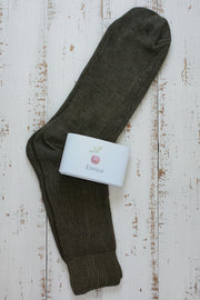 Dark brown sock with a white label on a rustic wooden surface