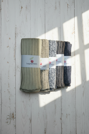 Set of leg warmers in various colors on a wooden surface