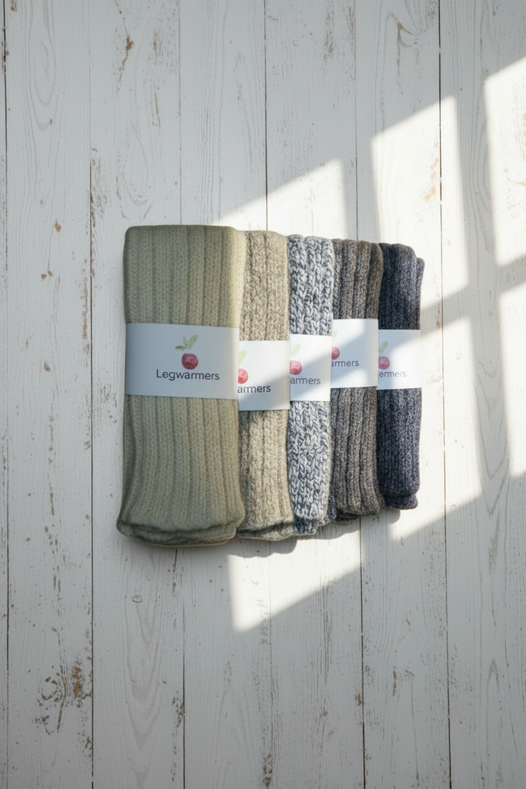 Set of leg warmers in various colors on a wooden surface