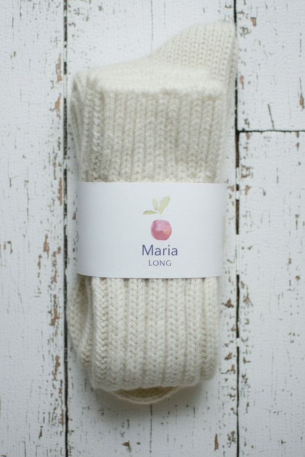 Knitted sock with a label on a wooden surface