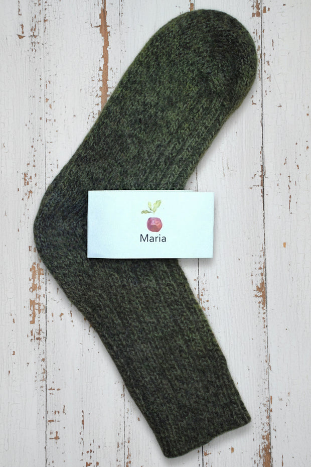 Mottled Green sock on a wooden surface with a 'Maria' label.