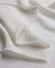 Close-up of white fabric with a subtle pattern