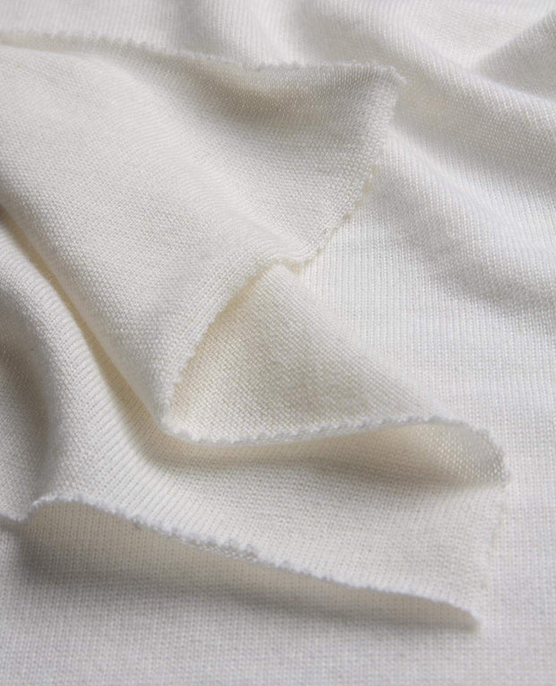 Close-up of white fabric with a subtle pattern