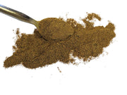 Spoonful of brown coreopsis extract powder on a white background