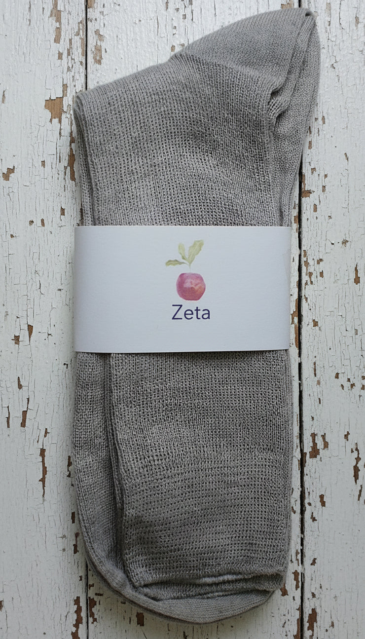 Gray sock with a white label on a wooden surface