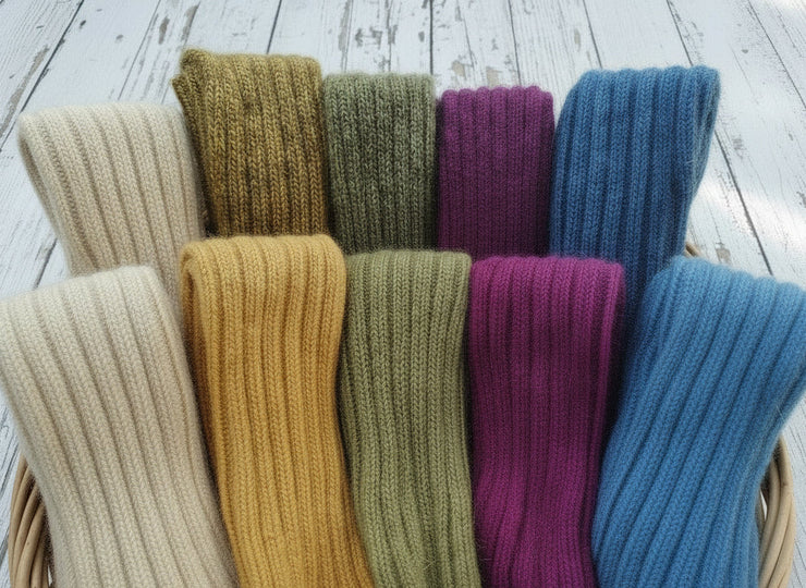 A basket full of blue, purple, green, yellow and white legwarmers