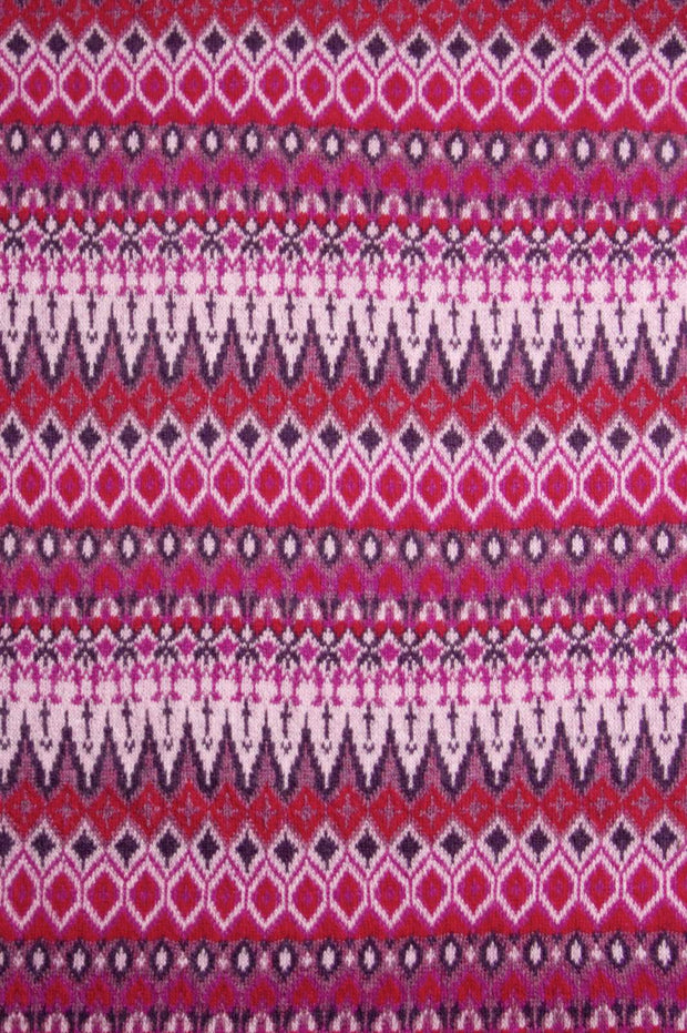Patterned fabric with a repeating geometric design in pink, purple, and white.