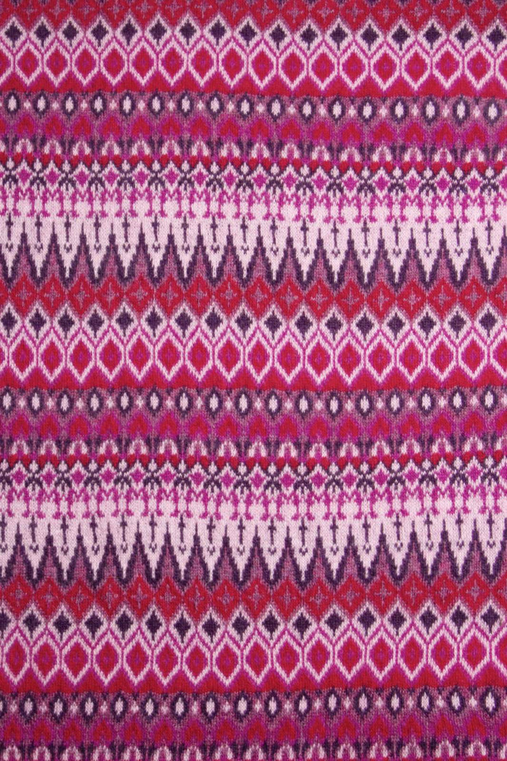 Patterned fabric with a repeating geometric design in pink, purple, and white.