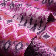 Close-up of a knitted fabric with a pink and purple pattern