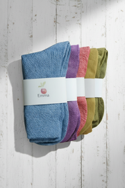 Set of colorful socks with 'Emma' branding on a wooden surface