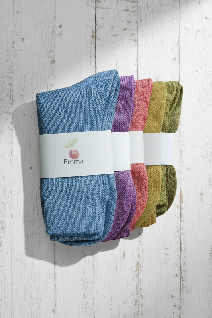 Set of colorful socks with 'Emma' branding on a wooden surface