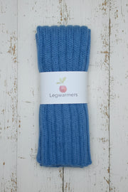 Pair of blue legwarmers on a white background with a label.