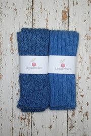 Pair of blue leg warmers with labels on a wooden surface