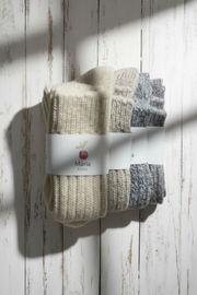 4 Pairs of socks with a brand label on a wooden surface