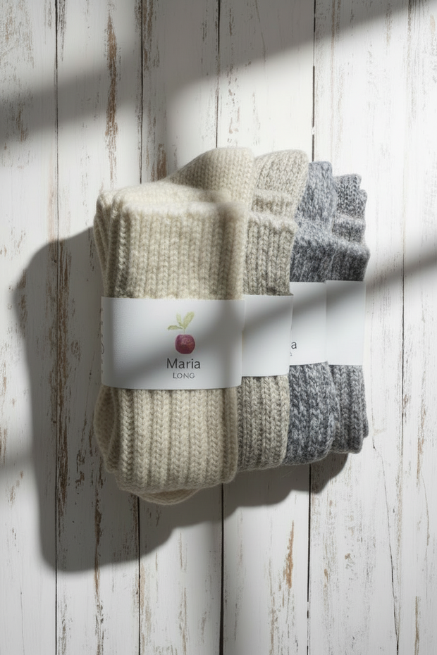 4 Pairs of socks with a brand label on a wooden surface