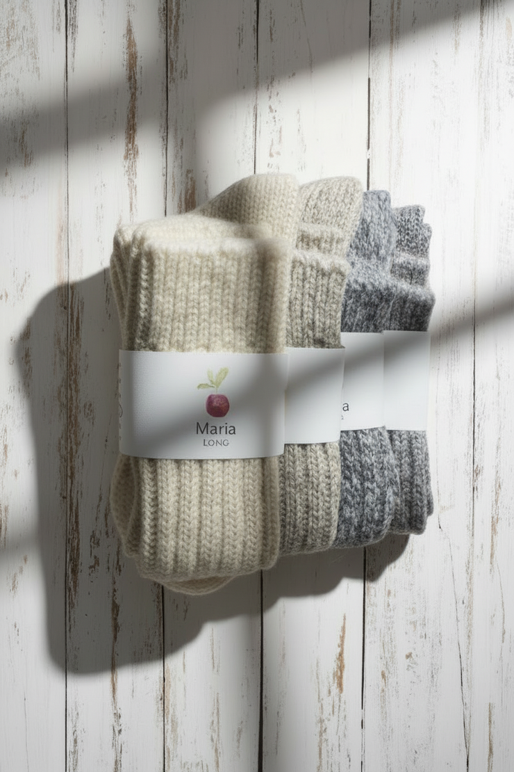 4 Pairs of socks with a brand label on a wooden surface