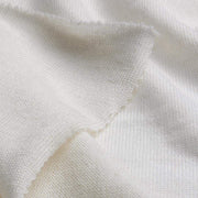 Close-up of white fabric with a visible stain.