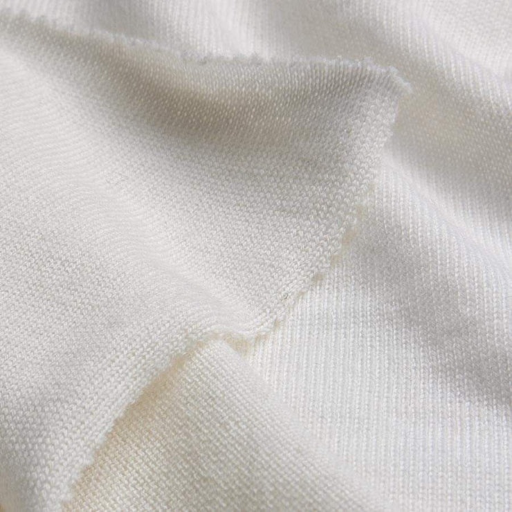 Close-up of white fabric with a visible stain.