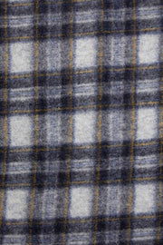 Close-up of a plaid fabric with gray, black, and white colors.