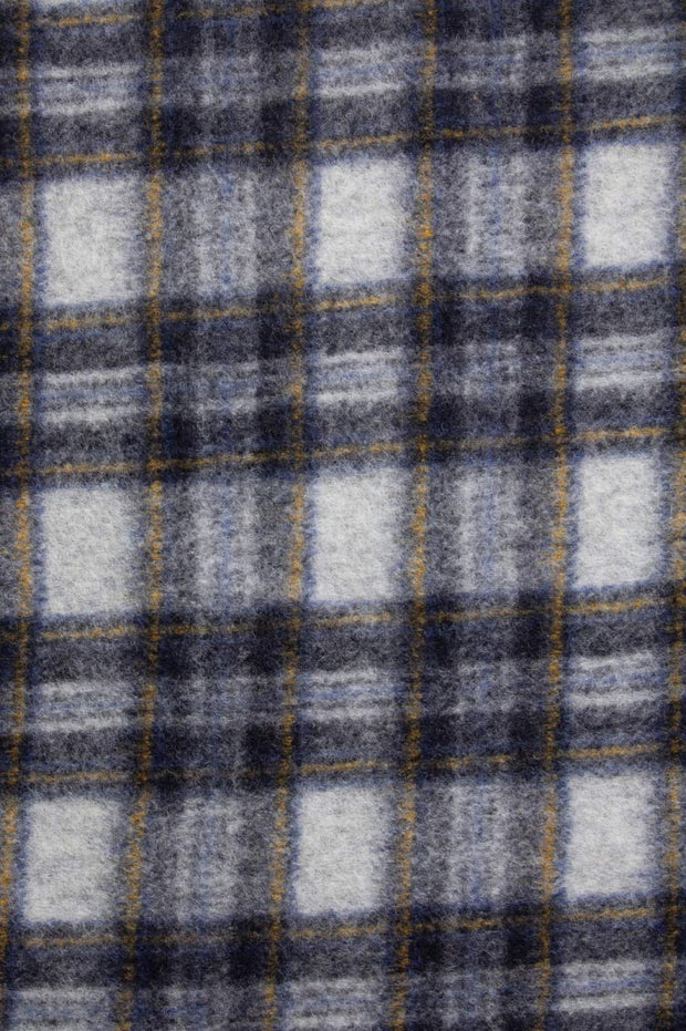 Close-up of a plaid fabric with gray, black, and white colors.