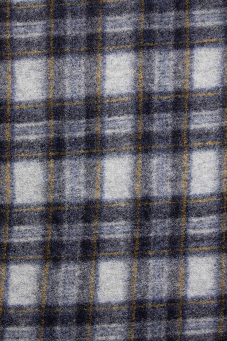 Close-up of a plaid fabric with gray, black, and white colors.
