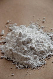 Cream of tartar powder on a wooden surface