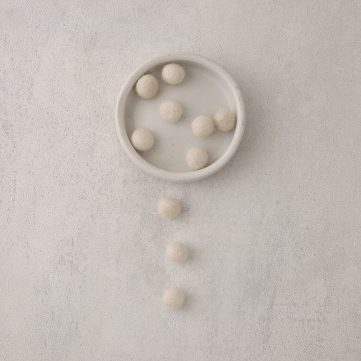 White felt beads in bowl