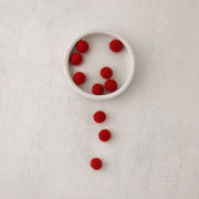 red felt beads in bowl