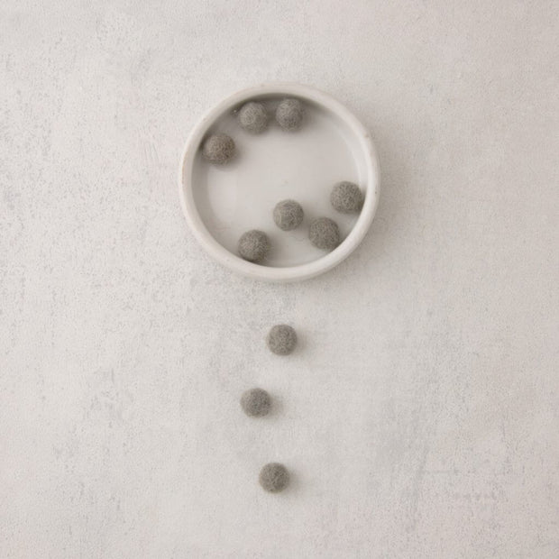 light grey felt balls in bowl